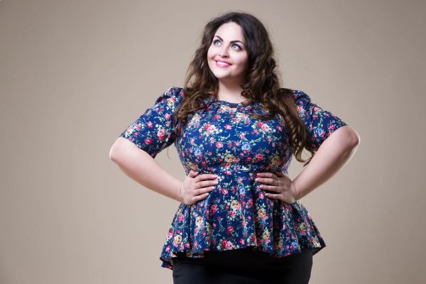 A woman in blue color floral top with black color jeans